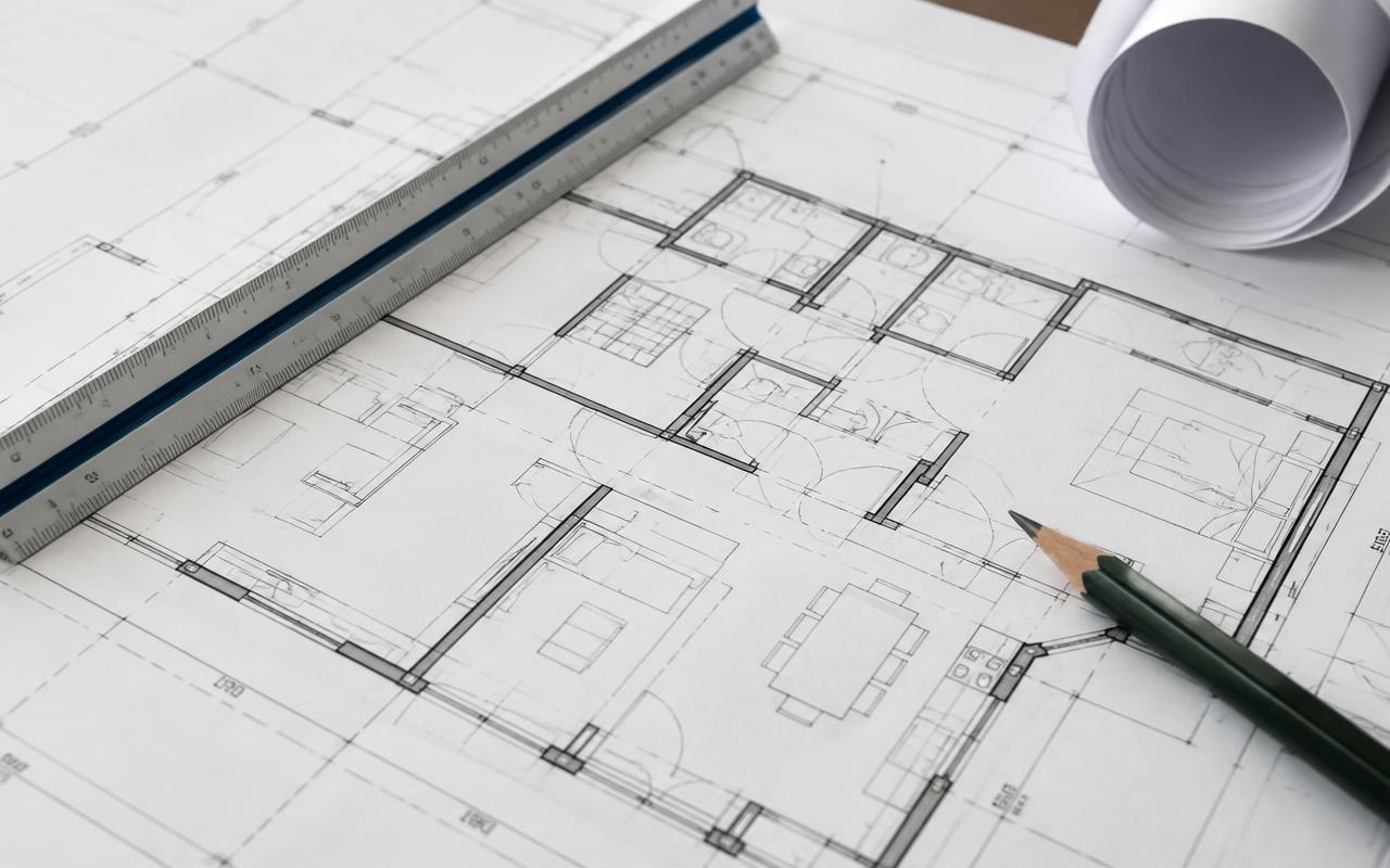House floor plan blueprints with scale ruler and pencil