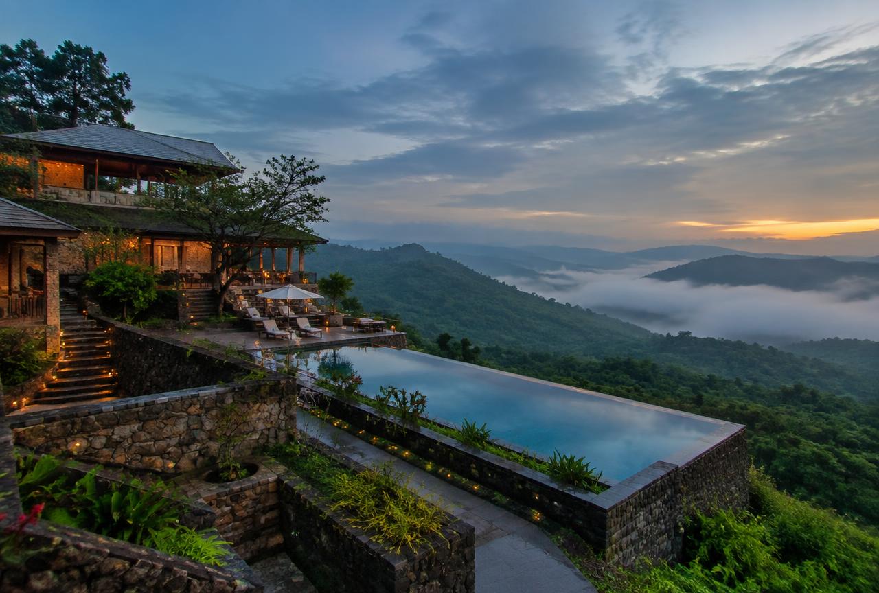 Resort-style clubhouse with infinity pool overlooking a Navi Mumbai creek