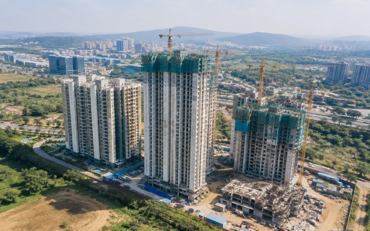 Aerial view of residential towers rising with cranes in Kharghar, Navi Mumbai